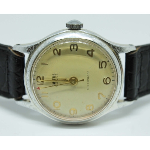 120 - A 1950s Smiths stainless steel mechanical wristwatch with gold tone Arabic numbers and hands, red ar... 