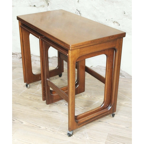 61 - A McIntosh teak nest of tables with swivel and fold over top.