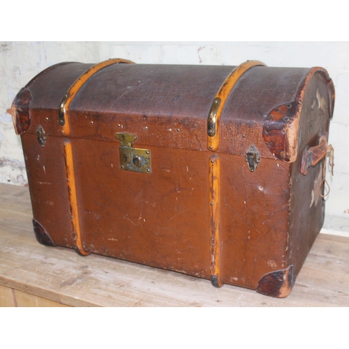 67 - A vintage wooden bound and domed top travel trunk with leather handles and interior tray, length 85c... 