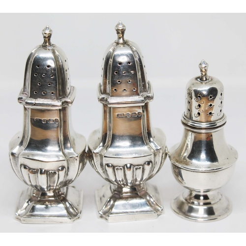 99 - A pair of silver pepper pots and another, wt. 3 1/2oz.