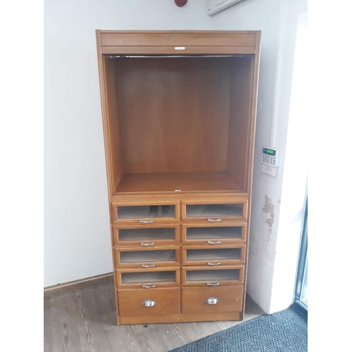 88 - A vintage haberdashery cabinet comprising an open top section with hanging space above eight glazed ... 