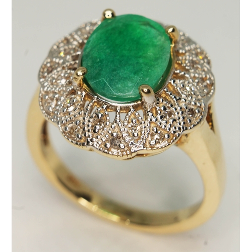 103 - An emerald and diamond ring, the central oval cut emerald approx. 2.14ct, band marked '14K', gross w... 