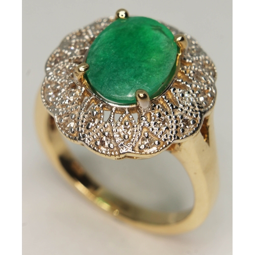 103 - An emerald and diamond ring, the central oval cut emerald approx. 2.14ct, band marked '14K', gross w... 