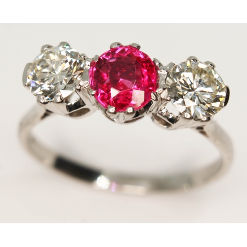 105 - A three stone diamond and ruby ring, the central oval cut ruby approx. 0.93 carats, total approx. di... 