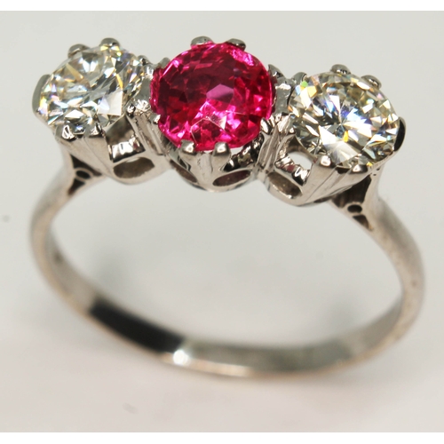 105 - A three stone diamond and ruby ring, the central oval cut ruby approx. 0.93 carats, total approx. di... 