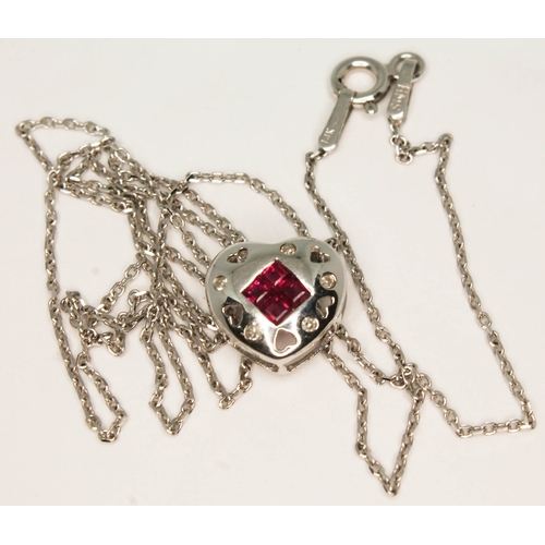 106 - A 14ct white gold diamond and ruby heart shaped pendant on 14ct white gold chain, both marked '14K',... 