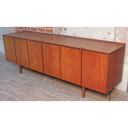 11 - A 1960s Danish style teak sideboard, length 228.5cm, depth 51cm & height 76cm.