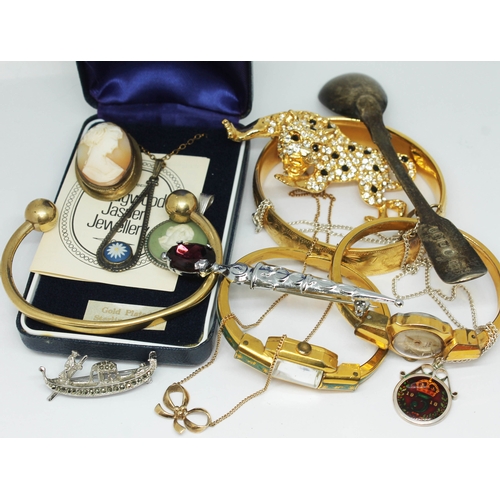 128 - A mixed lot of vintage jewellery including two gold plated bangle watches, a gold plated bangle, a p... 