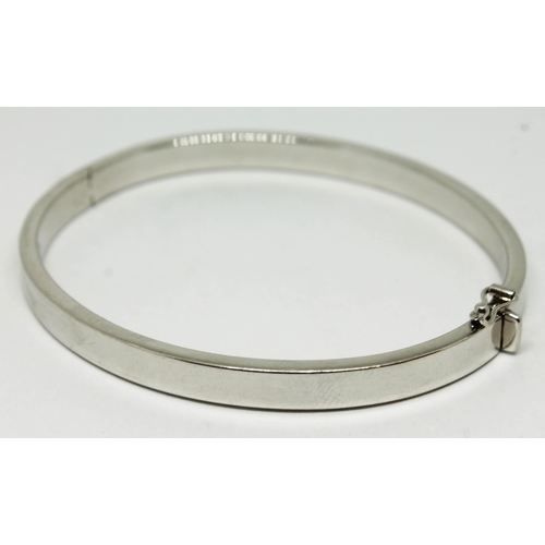 133 - A contemporary hallmarked 9ct white gold bangle, approx. diam. 58mm, wt. 10.2g.