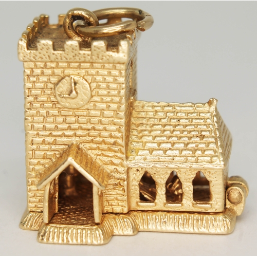 135 - A hallmarked 9ct gold charm formed as a church and opening to reveal a wedding ceremony, length 30mm... 