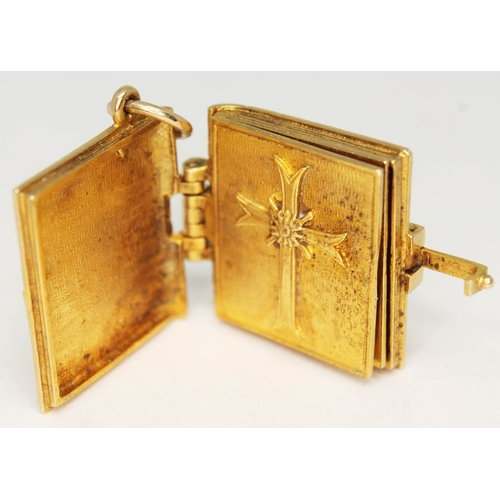 136 - A hallmarked 9ct gold charm formed as The Holy Bible, length 28mm, wt. 11.9g.