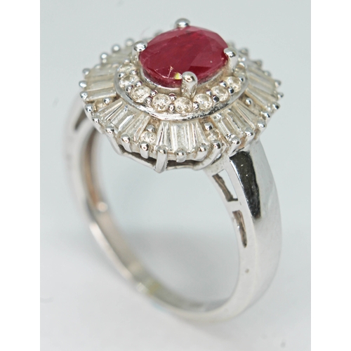 170 - A contemporary Art Deco style ruby and diamond cluster ring, the oval cut ruby set within a surround... 