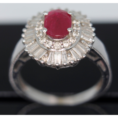 170 - A contemporary Art Deco style ruby and diamond cluster ring, the oval cut ruby set within a surround... 