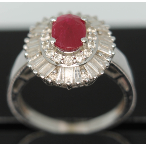 170 - A contemporary Art Deco style ruby and diamond cluster ring, the oval cut ruby set within a surround... 