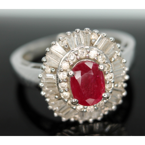 170 - A contemporary Art Deco style ruby and diamond cluster ring, the oval cut ruby set within a surround... 