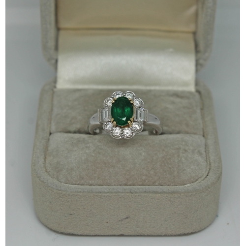 171 - A contemporary Art Deco style emerald and diamond cluster ring, the oval cut emerald set within a su... 