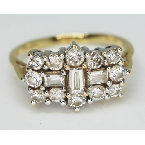 172 - A diamond cluster ring featuring three central baguette cut diamonds surrounded by 12 round brillian... 