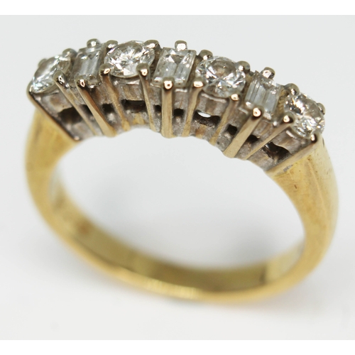 174 - A seven stone diamond ring comprising four round brilliant cut diamonds interspersed by three baguet... 