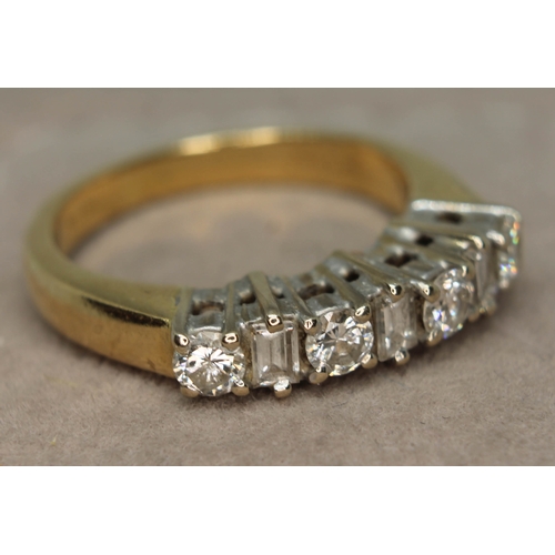 174 - A seven stone diamond ring comprising four round brilliant cut diamonds interspersed by three baguet... 