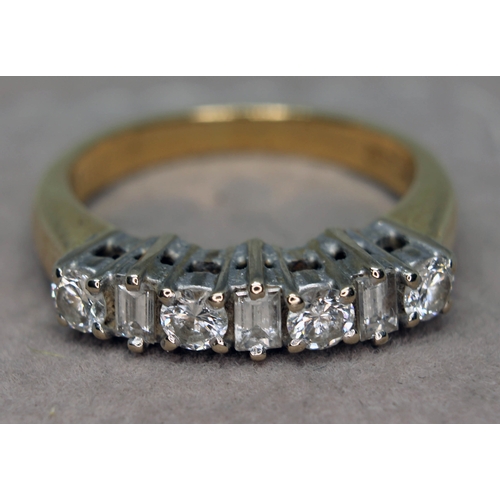 174 - A seven stone diamond ring comprising four round brilliant cut diamonds interspersed by three baguet... 