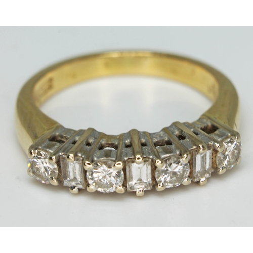 174 - A seven stone diamond ring comprising four round brilliant cut diamonds interspersed by three baguet... 