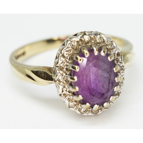 182 - An amethyst and diamond cluster ring, the oval cut central stone approx. 8mm x 6mm, depth 4.66mm, ha... 