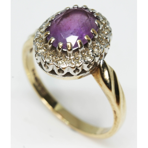 182 - An amethyst and diamond cluster ring, the oval cut central stone approx. 8mm x 6mm, depth 4.66mm, ha... 