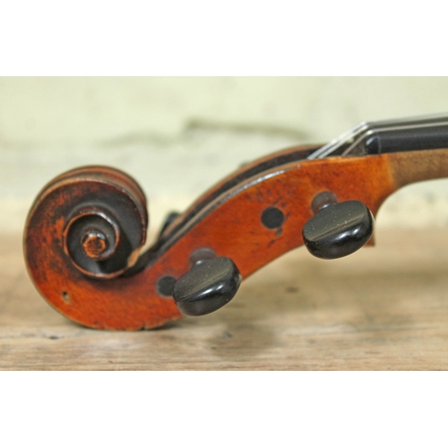 44 - A late 19th century violin labelled 'Maggini Deutsche Arbeit 1886', length of back 36.5cm, with bow ... 