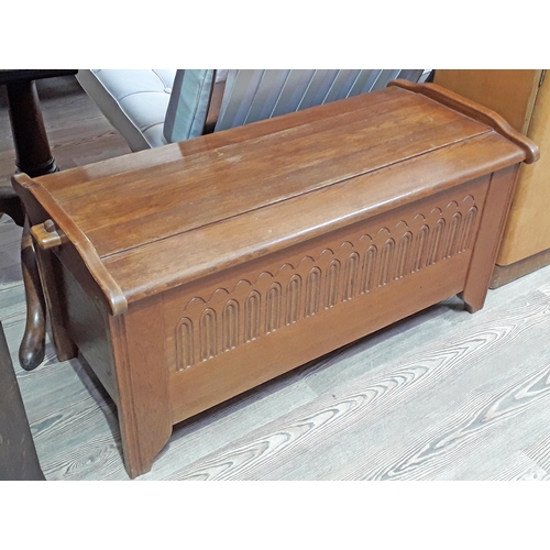 62 - An oak bedding chest with pegged joints to lid and carved detail to front, length 105cm.