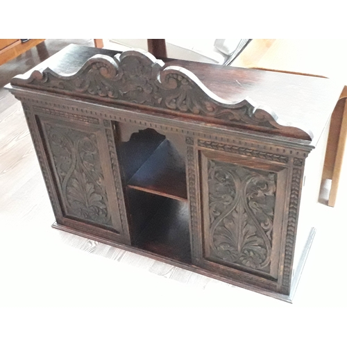 63 - A carved oak table cabinet, length 87cm.