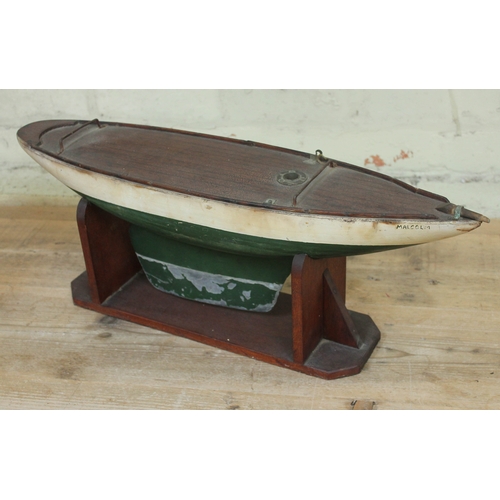 464 - A wooden model pond yacht on stand, length 62cm.