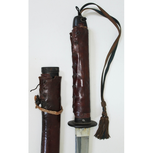 468 - A Japanese WWII officer's katana with bound fish skin grip black lacquered scabbard and leather cove... 