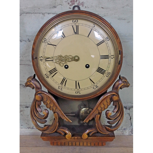 93 - A reproduction wall clock with carved griffins, dial diam. 24cm.