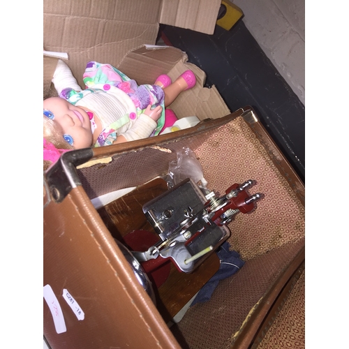 128 - A box with a childs sewing machine and a boxed doll