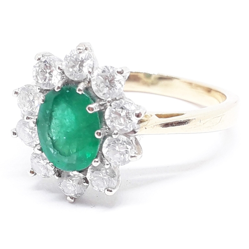 148 - A diamond and emerald cluster ring, the central translucent green stone approx. 1.07 carats, surroun... 