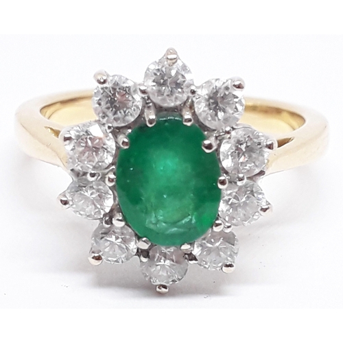 148 - A diamond and emerald cluster ring, the central translucent green stone approx. 1.07 carats, surroun... 