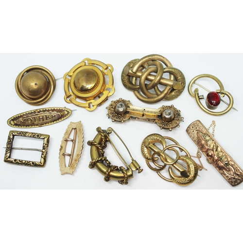 125 - A group of ten Victorian and later yellow metal brooches and a yellow metal buckle.