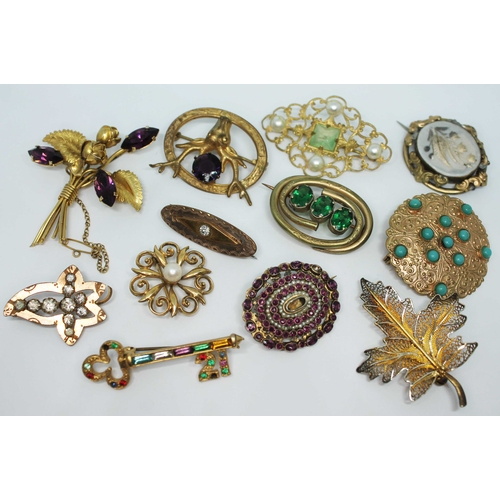 126 - A group of twelve Victorian and later yellow metal brooches, various settings.