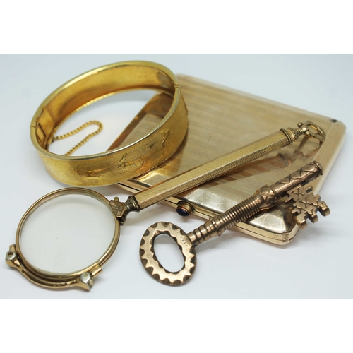 127 - A mixed lot of yellow metal comprising a rolled gold cigarette case, a lorgnette, a bangle decorated... 