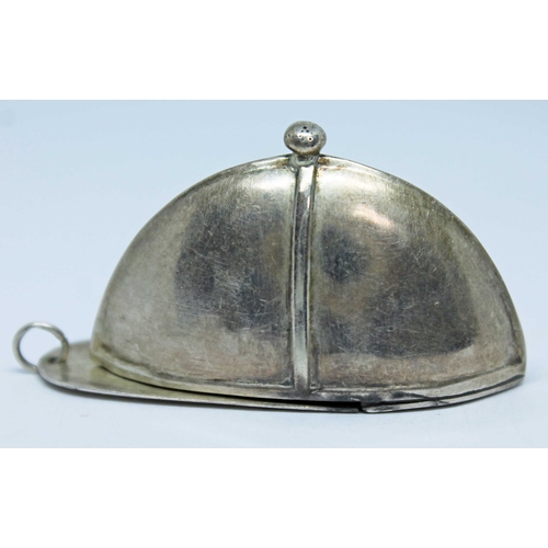 128 - A novelty silver vesta case formed as a jockey's cap, marked '925 STERLING', length 51mm.