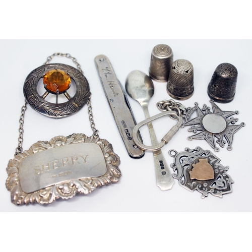 159 - A mixed lot of hallmarked silver comprising a sherry label, a pen knife, two fobs, three thimbles, a... 