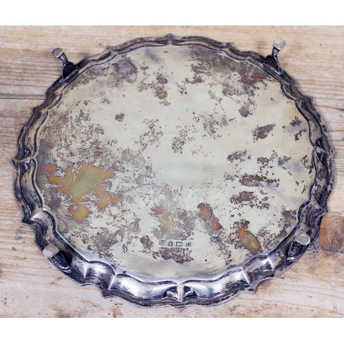 167 - A four footed hallmarked silver salver, diam. 26.5cm, wt. 18oz.