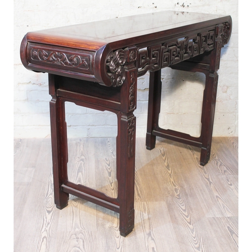 44 - A Chinese altar table, late 19th century, carved frieze with scroll ends and carved square legs, len... 