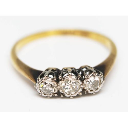 214 - A three stone diamond ring, marked '18ct PLAT', gross wt. 2.3g, size N.