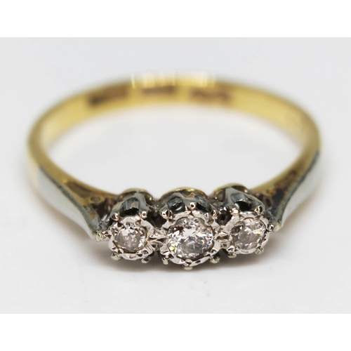 215 - A three stone diamond ring, marked '18ct PLAT', gross wt. 2.4g, size M.