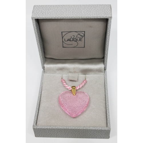 230 - A Lalique pink pressed glass heart shaped pendant with yellow metal loop and twist pink cord necklac... 