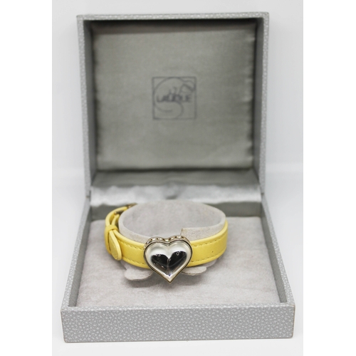 232 - A Lalique yellow leather bracelet having applied glass heart with white metal mounts and set with co... 