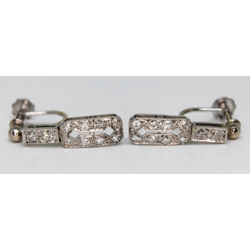 240 - A pair of Art Deco 18ct white gold diamond earrings, marked '750', gross wt. 3.7g, length 19mm each.