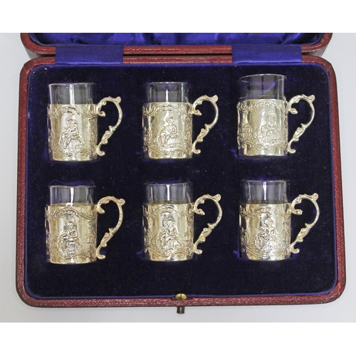 243 - A cased set of six silver liquor tots with continental style decoration and glass liners, James Dixo... 