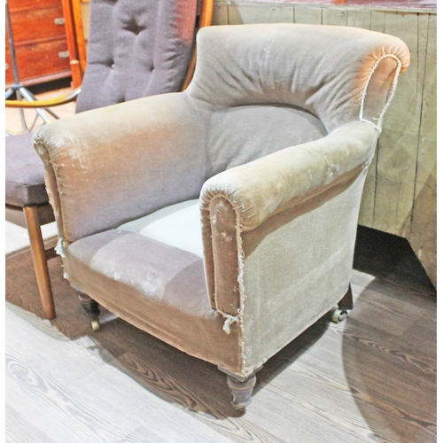 73 - A Victorian armchair with turned legs and brass castors.